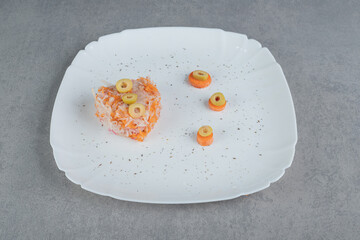 Orange color carrot salad with mixed ingredients and cherry tomatoes