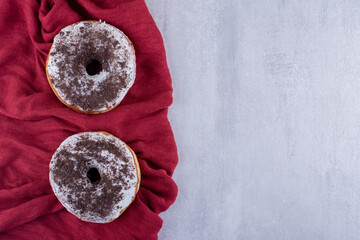 Savory donuts on tablecloth on white background