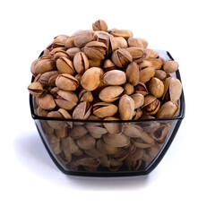 Salted pistachios in glass bowl isolated on white background