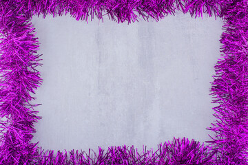 Frame made of purple garland on white background