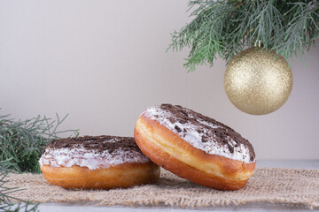 Donuts placed amid decorative arrangement on white background