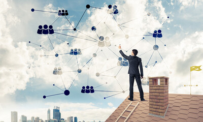 Businessman on house roof presenting networking and connection c