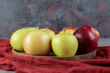 Mixed apple bundle on a tray on marble background