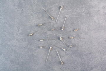 Tips of metal syringes on marble surface