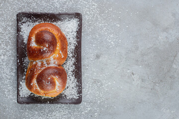 Jam filled sweet bun on a platter on marble background