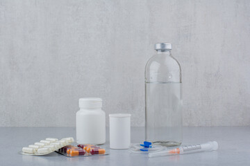 Various drugs, syringe and ampoule on marble surface
