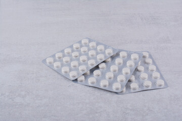 Three packs of medical drugs on marble surface