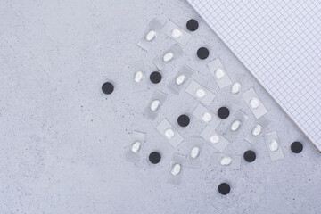 Pharmaceutical drugs with notebook on marble background