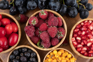 A wooden bowls full of delicious berries