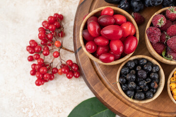 A wooden bowls full of delicious berries