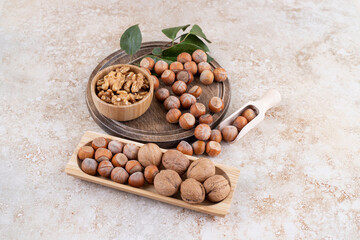 A wooden bowl of macadamia nuts and walnuts