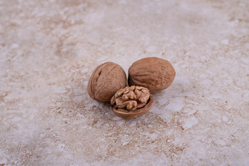 Three healthy delicious walnuts on marble background