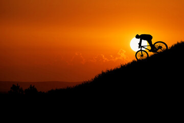 Mountain biker silhouette going downhill. Mountain bike concept and adventure.