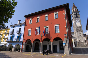 Red town hall at village of Ascona, Canton Ticino, on a sunny summer day. Photo taken July 24th, 2022, Ascona, Switzerland.