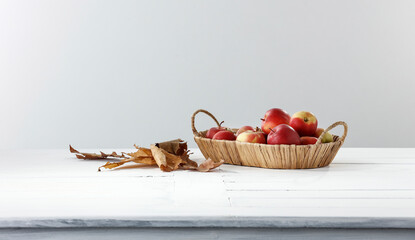 A white minimalist table with an autumn composition on a smooth wall in the kitchen and a free space