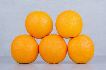 Five whole delicious oranges on white background