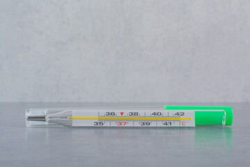 Single thermometer isolated on marble background
