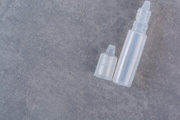 Naklejka premium Plastic parts of syringe on marble background
