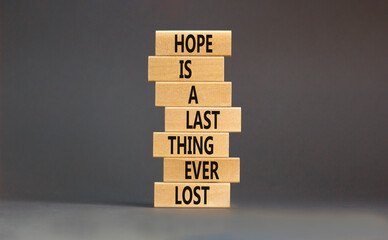 Do not lost hope symbol. Concept words Hope is a last thing ever lost on wooden blocks on a beautiful grey table grey background. Business motivational and do not lost hope concept.