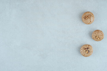 Three sweet round cookies with walnut on white background
