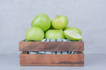 Fototapeta na wymiar Green tasty apples in wooden basket