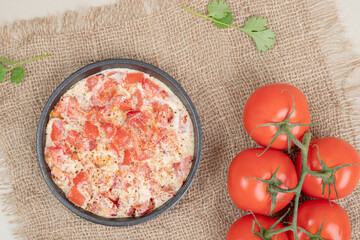 Delicious omelet with tomatoes on wooden board