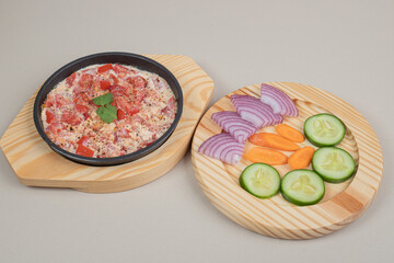 Delicious meal with sliced vegetables on wooden board