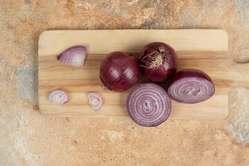 A wooden cutting board with sliced onion