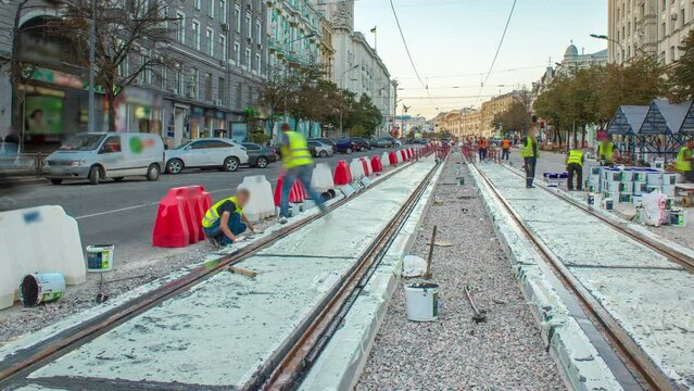 Tram rails in concrete plates on the road timelapse. Filling by liquid resin for reduction of vibration and noice. The process of reconstruction of tram tracks