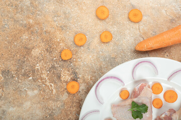 Uncooked chicken leg with chili peppers on marble background