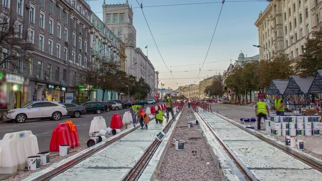 Tram rails at the stage of their integration into concrete plates on the road timelapse. Filling by liquid resin for reduction of vibration and noice. The process of reconstruction of tram tracks in