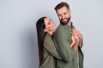 Fototapeta premium Profile side photo of young cheerful couple look each other feelings romance isolated over grey color background