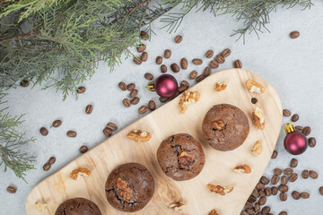 Chocolate cookies with walnuts and coffee beans on wooden board