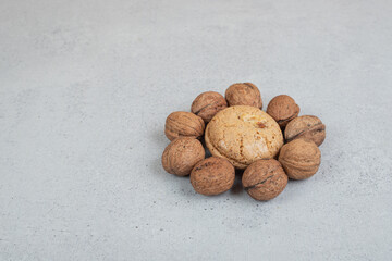 Round sweet cookies with walnuts on white background