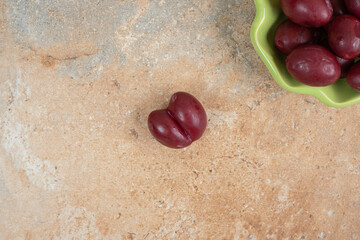 Pickled cornel cherries in green bowl
