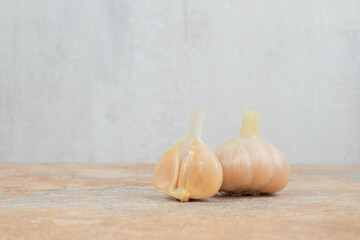 Homemade fermented garlic on marble background