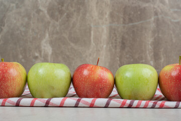 Colorful fresh apples on striped tablecloth