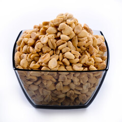 pile of spiced peanuts isolated close up on white background 