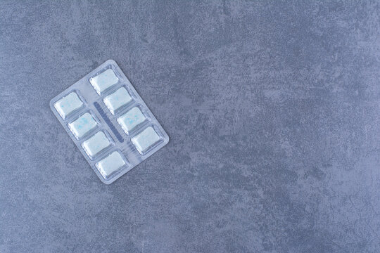 A Pack Of Blue Gum Tablets On Marble Background