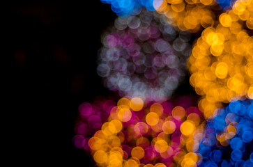 Abstract colorful soft blurred bokeh on black background. Shining and blurred circles lights bokeh...