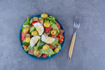 Delectable salad mix with breakfast ingredients on marble background