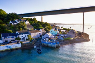 Bird's eye view of the Cleddau Bridge over residential buildings and a river
