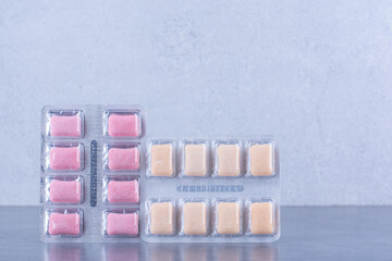 Two bubblegum tablet packs on marble background