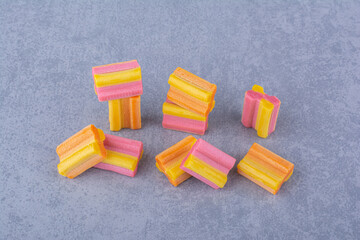 Handful of colorful chewing gum pieces on marble background