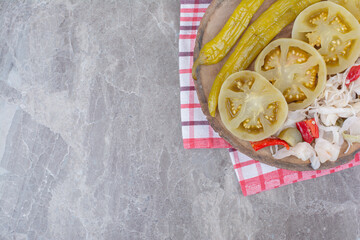 Fototapeta na wymiar Variety of chopped pickles on wooden piece