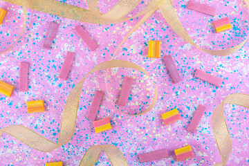 Golden ribbons and scattered bubblegums all over a colorful background