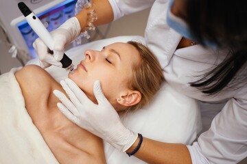 A cosmetologist performs hydropiling in a beauty salon. Skin care.