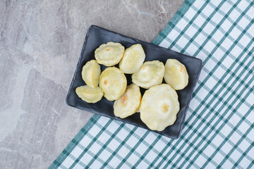Homemade pickled vegetables on black plate