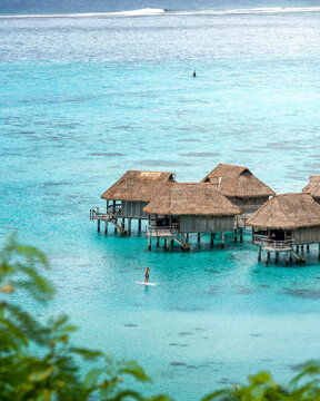 View of a person doing paddle board along the reef in Tahiti, French Polynesia.