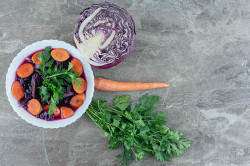 A light salad and the ingredients arranged on marble background
